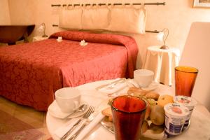 Postel nebo postele na pokoji v ubytování Anfiteatro B&B