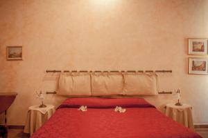 Postel nebo postele na pokoji v ubytování Anfiteatro B&B