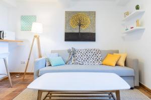 a living room with a blue couch and a table at Casa Angelita terraza con hórreo y barbacoa in Poio +52 photos