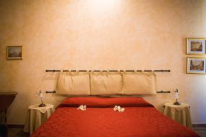 Postel nebo postele na pokoji v ubytování Anfiteatro B&B