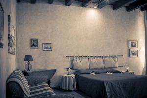 Postel nebo postele na pokoji v ubytování Anfiteatro B&B