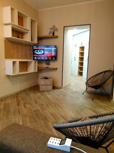 a living room with a tv and a couch at Tbilisi Apart in Tbilisi City