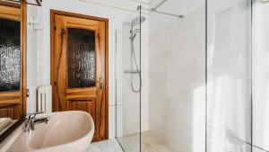 a bathroom with a sink and a glass shower door at Villa Dervio in Dervio