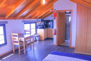 a kitchen with a table and chairs in a room at Studio One | Massapez | Fajã da Ovelha | Calheta in Fajã da Ovelha