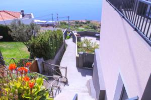 a stairway leading up to a house with flowers at Studio One | Massapez | Fajã da Ovelha | Calheta in Fajã da Ovelha