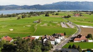 an aerial view of a village with a lake and mountains at Hotel Alpenblick Attersee-Seiringer KG in Attersee am Attersee