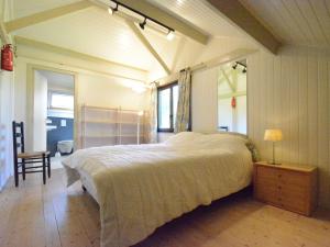 a bedroom with a large bed and a mirror at Luxury Pet friendly Chalet in Bi vre near Forest in Bièvre