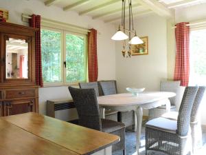 a dining room with a table and chairs at Luxury Pet friendly Chalet in Bi vre near Forest in Bièvre