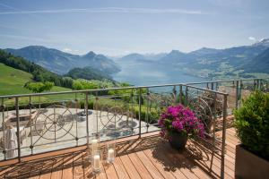 a balcony with a view of a lake and mountains at Hotel Villa Honegg in Ennetbürgen