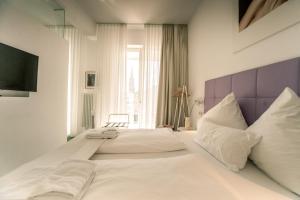 Postel nebo postele na pokoji v ubytování MAISON MARSIL - Boutique Hotel Köln
