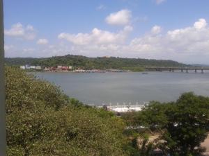 a boat in the water next to a bridge at Panaji Residency in Panaji