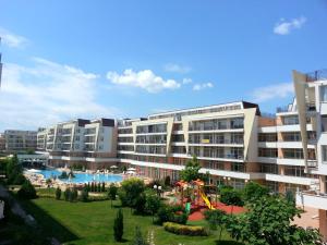 a large apartment building with a playground in front of it at Menada Grand Kamelia Apartments in Sunny Beach