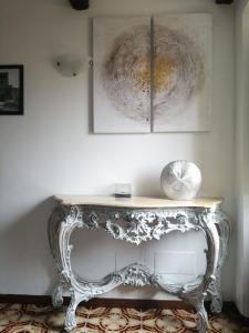 a console table in a room with two pictures on the wall at Antico Borgo in Bagnoregio