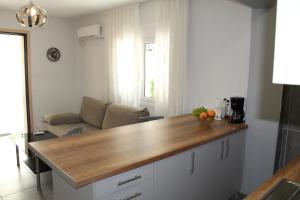 a kitchen with a wooden counter top in a room at Апартаменты Пластира in Athens