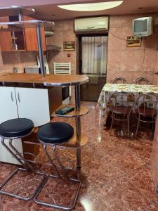 a kitchen with a table and chairs in a room at casa lux central in Slatina
