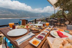 a table with food on it with a view of the water at Hillcity Hotel in Kaş