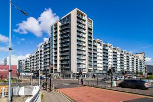 a large white apartment building on a city street at Glasgow City Flats in Glasgow