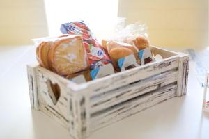 a wooden crate filled with different types of bread at Desidora B&B in Mirabella Eclano