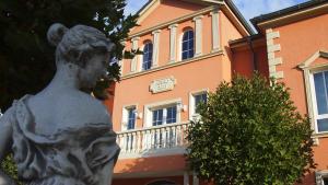a statue of a girl in front of a building at Hotel Garni am Schloss in Kottenheim
