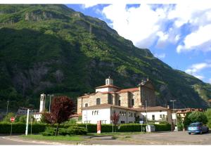 a large building in front of a mountain at B&B I Viandanti in Piancogno