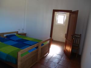 a bedroom with a bed and a door with a window at casa Bandoleros in Arenas
