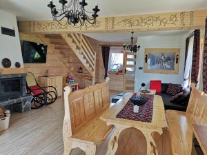 a living room with a wooden table and a dining room at Domek u Matusa in Biały Dunajec