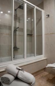 a bathroom with a large window and a shower at Pensión O Prouso in Carnota
