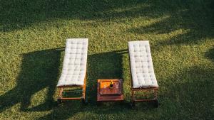 two chairs with white cushions sitting on the grass at Villa Dervio in Dervio
