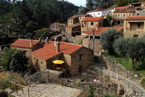 un pueblo con un edificio con una sombrilla amarilla en Casa da Eira - Água Formosa _ Vila de Rei, en Vila de Rei