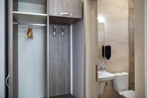 ein Badezimmer mit Toilette und Waschbecken und einer Tür in der Unterkunft Airport House in Otopeni