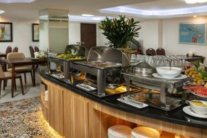 a buffet in a hotel with food on a counter at Diamond Legend Hotel in Hanoi