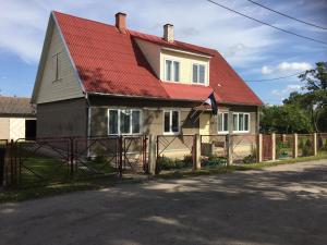a house with a red roof and a fence at Angelhouse studio in Tartu