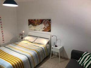 a bedroom with a bed and a painting on the wall at Playa de Caleta de Famara in Famara