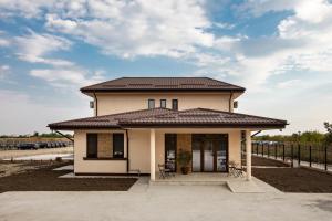 a small house with a roof at Airport House in Otopeni