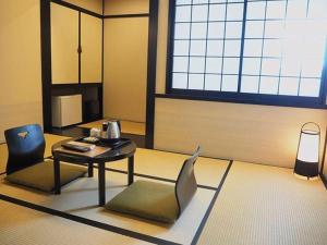 a living room with a table and a chair at The Edo Sakura in Tokyo