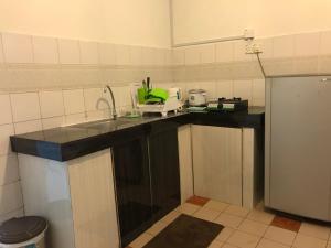 a kitchen with a sink and a counter top at Nusantara Mattwaddien M.S in Kota Kinabalu