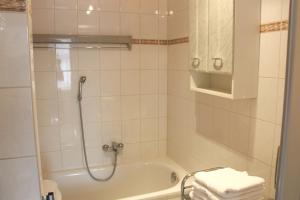 a bathroom with a shower and a tub with towels at Ferienwohnung Zum Lilienstein in Bad Schandau