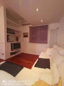 a living room with a white couch and a tv at casa dolce casa in Modena