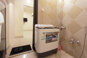 a small bathroom with a shower and a sink at Al Qaswaa Furnished Apartements in Buraydah