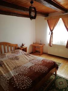 um quarto com uma cama e uma grande janela em Rustic Rooms em Rîşnov