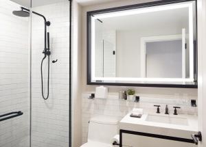 a bathroom with a shower, sink, and toilet at The Whitney Hotel Boston in Boston