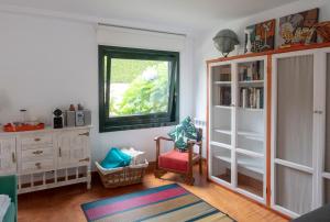 a childs room with a chair and a window at Casa Lourido in Sada
