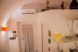 a white room with a white door and a shelf at Casa Nori in Polignano a Mare