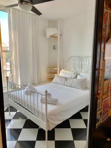 a white bed in a room with a black and white floor at Shantell Luxury Apartment in Netanya