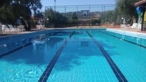 a large swimming pool with blue water at Villa Macchione in Mattinata