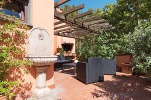 a stone fountain in the middle of a patio at The Spanish Steps Grand Penthouse in Rome