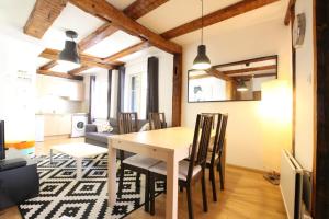 a dining room and living room with a table and chairs at Colmar Historic Center - Alsacian Appartement PETITE VENISE 1 - BookingAlsace in Colmar