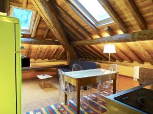 a kitchen with a table and chairs in a attic at Villa Ottocento in Campertogno