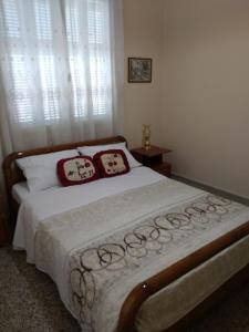 a bedroom with a bed with two pillows on it at Paraskevi's House in Argos