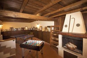 a room with a fireplace and ping pong tables at LA VALLETTA MAISON in Ponteranica